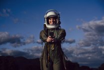 Smiling female astronaut taking selfie mobile phone in evening nature — Stock Photo