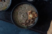 Mushroom cream soup with croutons in bowl on tray — Stock Photo