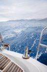 Detail of sailboat on high seas under cloudy sky — Stock Photo