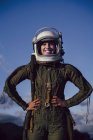 Confident smiling female astronaut standing in nature in evening — Stock Photo