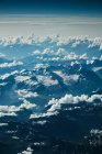 View on mountain and clouds from plane — Stock Photo