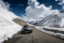 Moving car in mountain road in Alps — Stock Photo