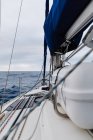 Detail of sailboat on high seas under cloudy sky — Stock Photo