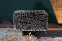 Closeup shot of cracked piece of old wood with crooked ornament on sunny day in Tyulenovo, Bulgaria — Stock Photo