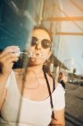 Young woman blowing bubbles — Stock Photo