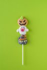Halloween candies on stick on green background — Stock Photo