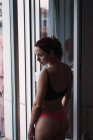 Young sensual woman in lingerie standing at balcony — Stock Photo