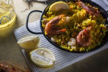 Traditional spanish paella marinera with rice, prawns, squid and mussels in pan — Stock Photo