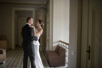 Married couple dancing inside luxury building — Stock Photo