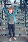 Shouting barefoot boy with skateboard standing on stairs — Stock Photo