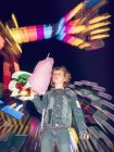 Boy with candy floss on funfair — Stock Photo