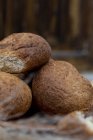 Fresh baked buns in heap on blurred background — Stock Photo