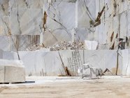 Huge marble blocks on ground on sunny day in quarry — Stock Photo