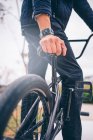 Cropped image of biker near bicycle — Stock Photo