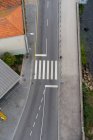 From above asphalt route with crosswalk between walkway and old buildings in Porto, Portugal — Stock Photo
