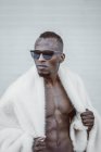 Stylish black man in fur coat — Stock Photo