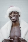 Excited black man in Santa Claus costume — Stock Photo