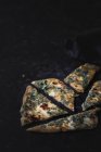 Slices of baked gozleme on dark surface — Stock Photo