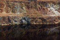 Calm surface of water near slope of quarry in Santo Domingos Mine, Portugal — Stock Photo