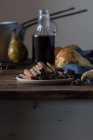 Fresh pears near spices and wine on wooden table — Fotografia de Stock