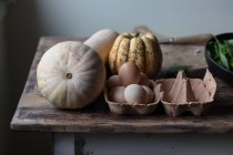 Various ingredients for delicious pumpkin and spinach frittata on timber tabletop — Stock Photo