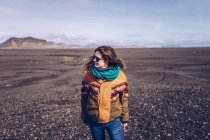 Sorridente umano con in piedi tra terreni oscuri in Islanda — Foto stock