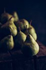 Juicy and ripe pears on dark wooden background — Stock Photo