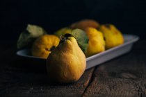 Quince fruit on dark wooden background — Stock Photo