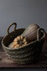 Rustic wicker basket with fall pumpkins — Stock Photo