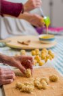 Hands working with dough and decorating pastry — Stock Photo