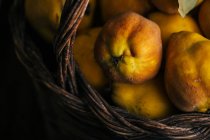 Closeup of fresh ripe quinces in basket — Stock Photo