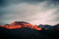 Cloudy sky over mountain ridge at sunset — Stock Photo