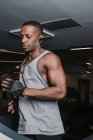 Black man running on treadmill in gym — Stock Photo