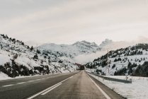 Snowy route running between mountains in Pyrenees — Stock Photo