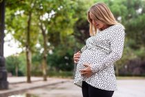 Pregnant attractive woman on street — Stock Photo