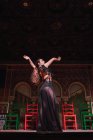 Young woman in dress dancing flamenco on scene in luxury oriental room decorated by mosaic — Stock Photo