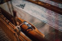 Wooden loom with blue treads — Stock Photo