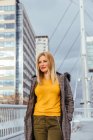 Blonde girl walking in the city — Stock Photo