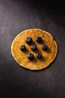 Closeup delicious pancake with ripe blueberries on dark gray tabletop — Stock Photo