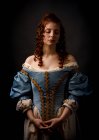 Beautiful woman in medieval clothing on black background. — Stock Photo