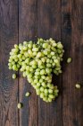 Bunch of green ripe grapes on wooden table. — Stock Photo
