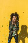 Black woman with afro hair throwing confetti to celebrate a very special day — Stock Photo