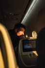 Homem atencioso olhando pela janela do avião — Fotografia de Stock