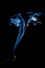 Вереницы ярко-синего дыма на черном фоне — стоковое фото