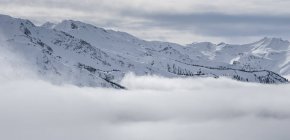 Picturesque view of peak of mountains in clouds and snow in Canada — Stock Photo