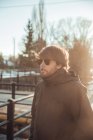 Young man with sunglasses near mountains in snow in Cerdanya, France — Stock Photo