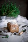Delicious fresh aromatic rye bread on napkin near knife on blurred background — Stock Photo