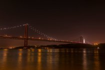 View to river and big illuminated Golden Gate bridge at night in San Francisco, California, USA — Stock Photo