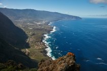 Panoramic view of shoreline with majestic cliffs and blue ocean waves from height, Canary Islands — Stock Photo