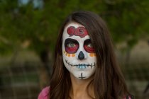 Jeune femme avec peinture effrayante visage — Photo de stock